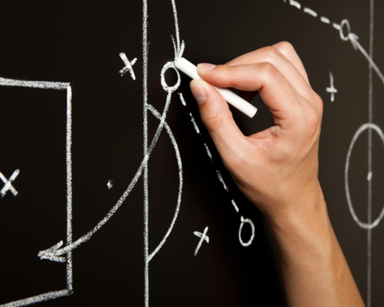 strategy explained on blackboard with chalk